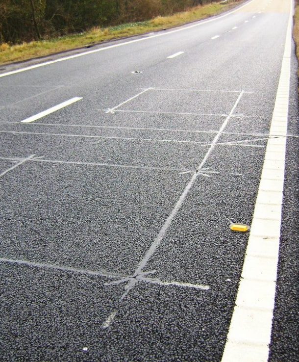 Inductive detector loops cut into the road surface at a traffic signal approach
